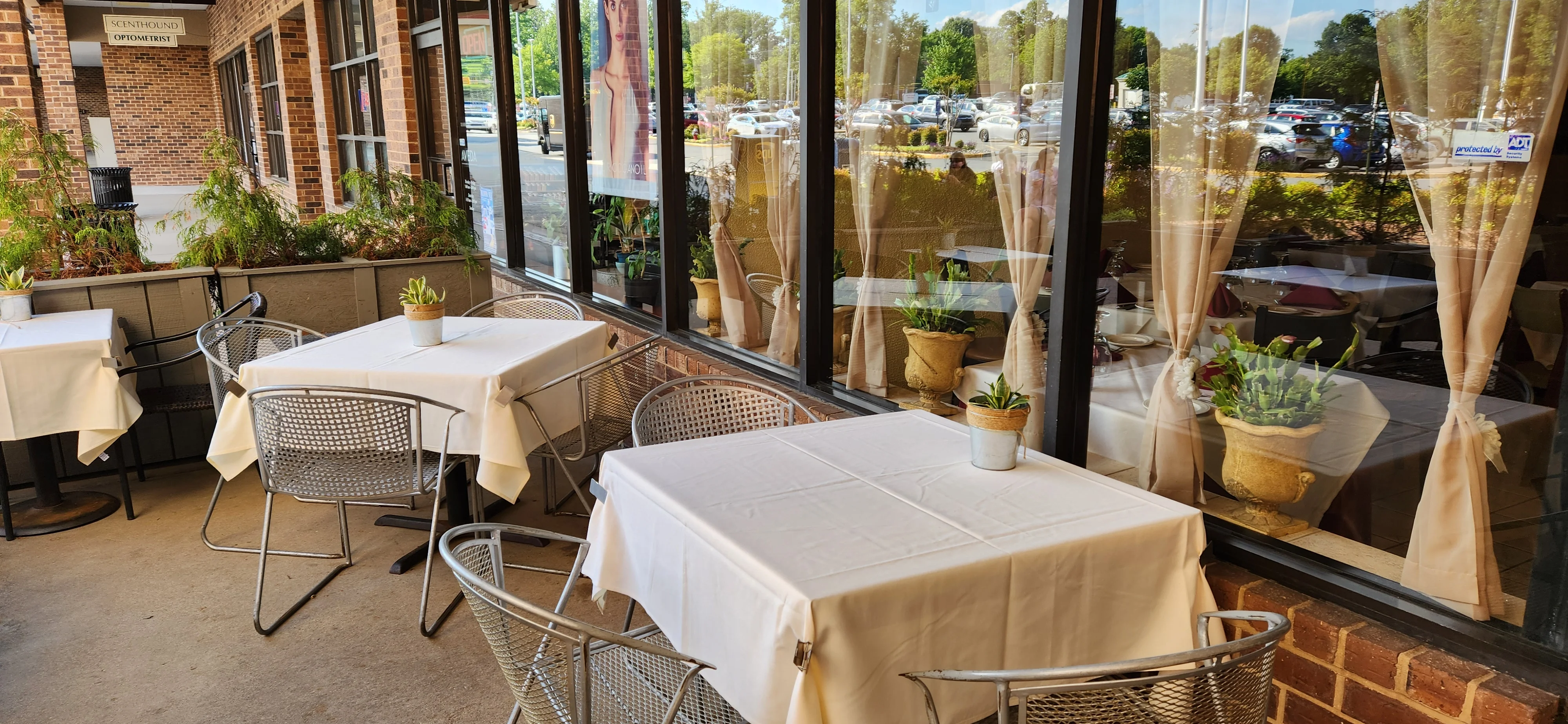 Outdoor dining area with tables and plants