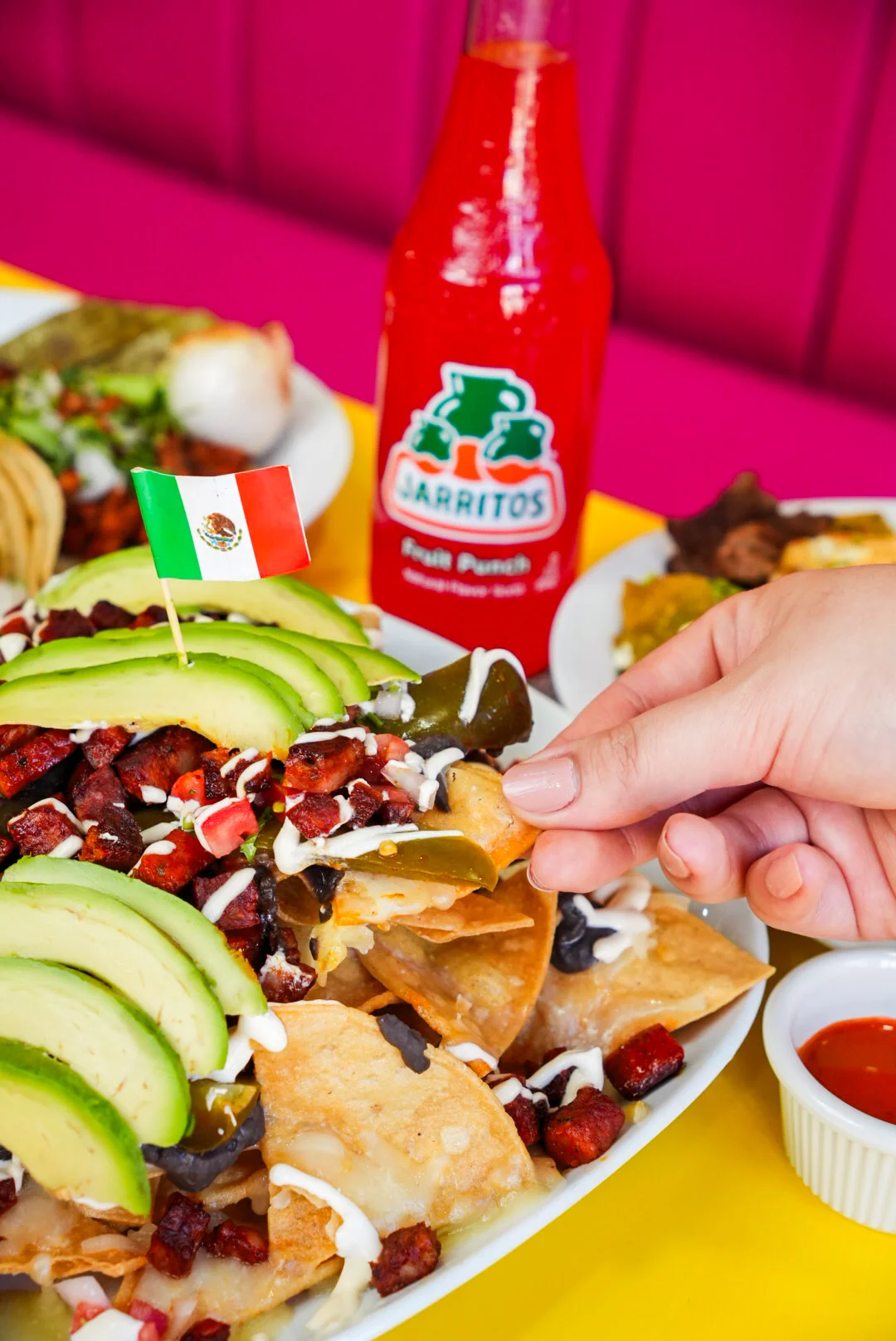 Loaded Mexican nachos topped with avocado and jalapeños