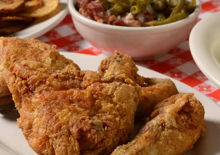 Southern fried chicken with sides on a checkered tablecloth