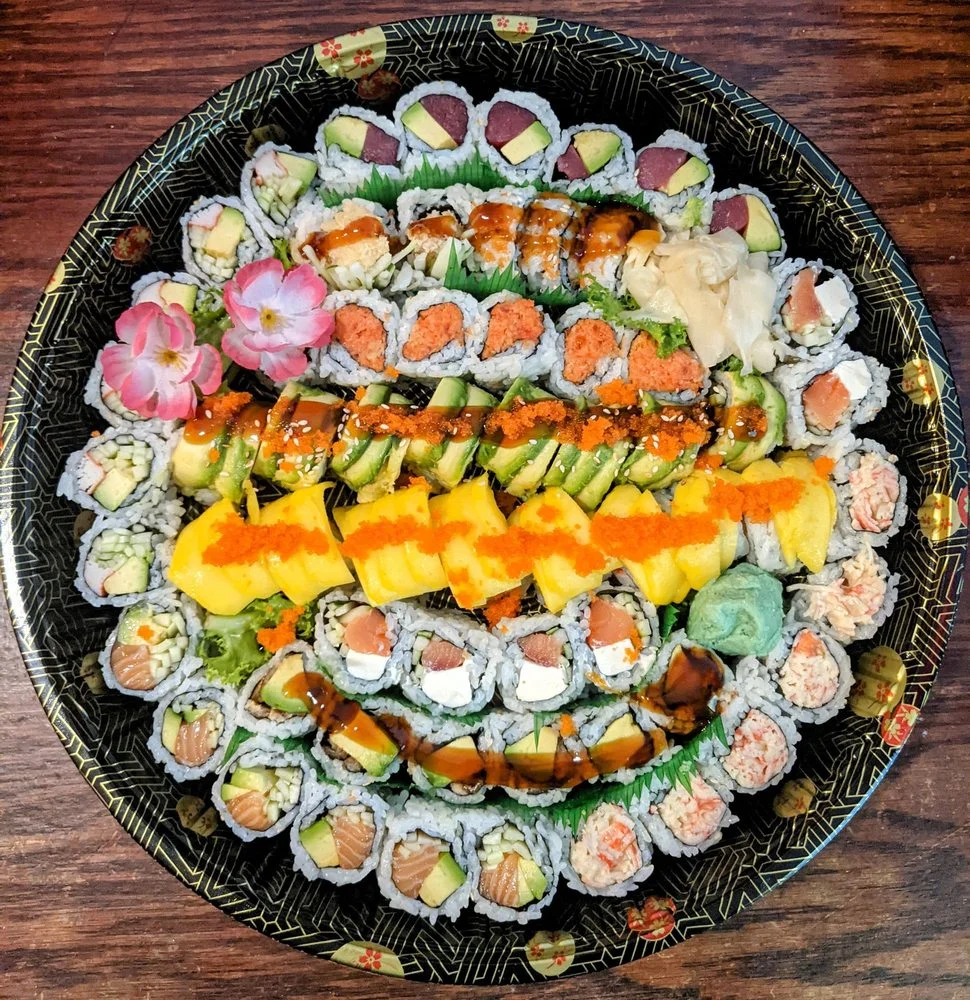 Assorted Japanese sushi platter with colorful rolls and garnishes