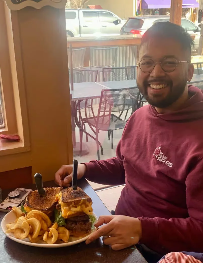 Giant cheeseburger with curly fries in a cozy restaurant