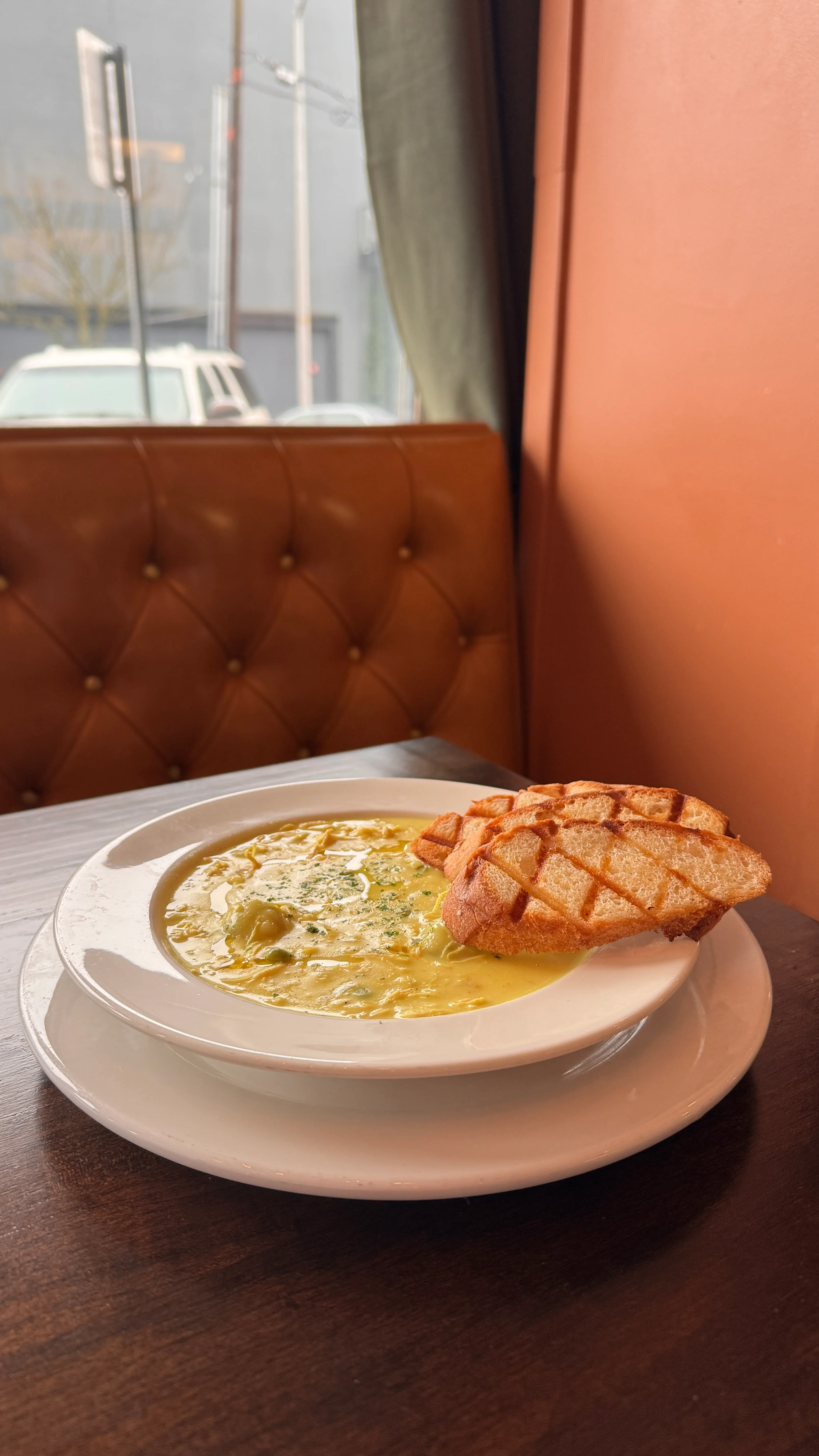 Creamy chowder served with toasted bread in a cozy restaurant setting