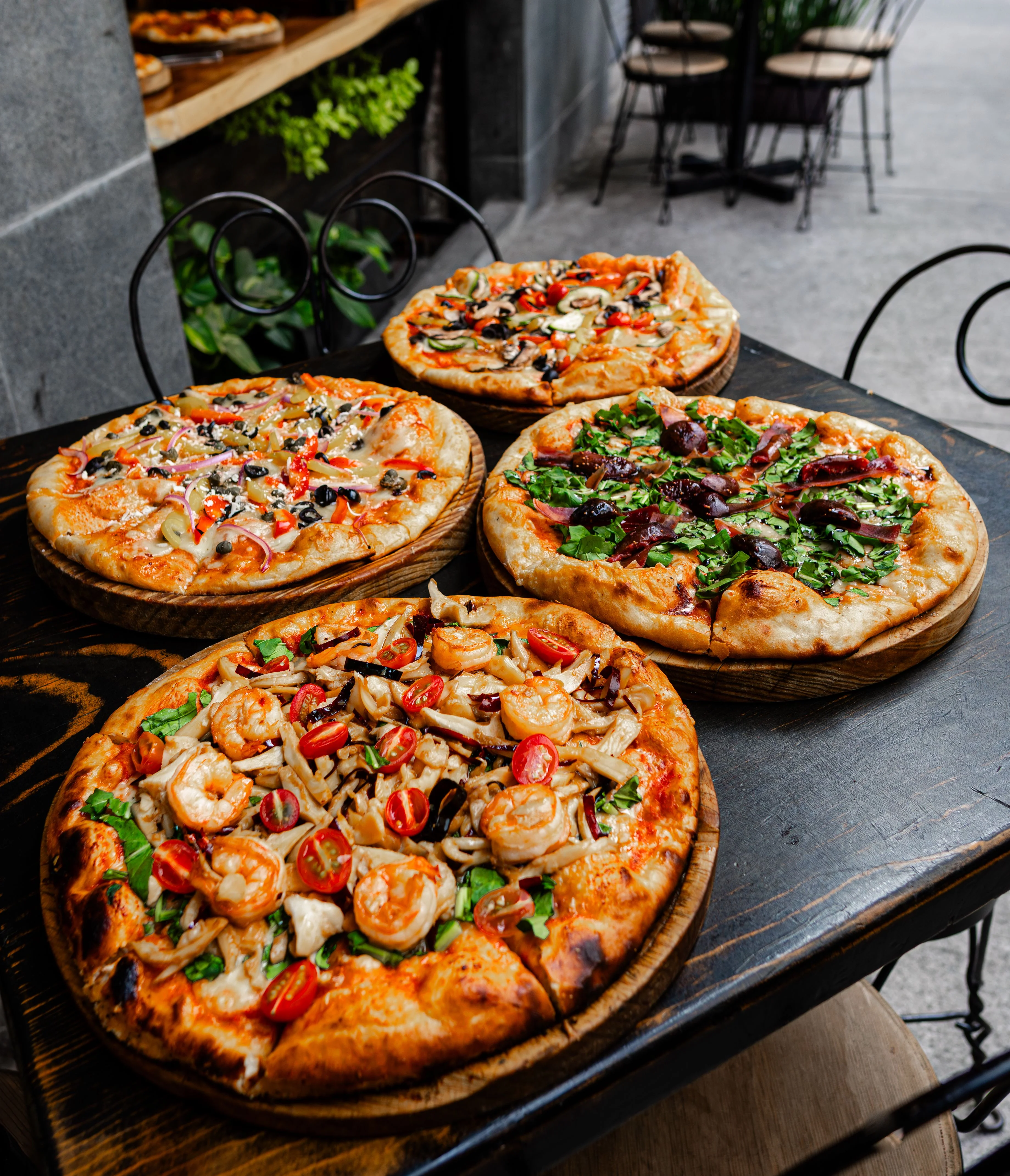 Assortment of Italian pizzas served on wooden boards