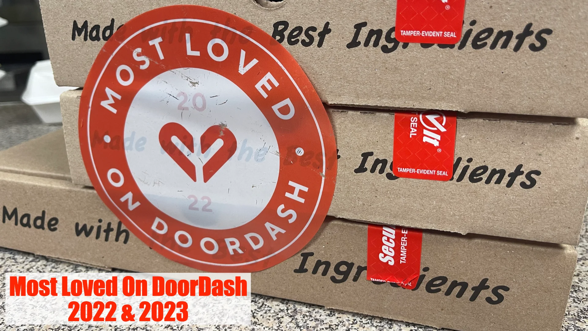 DoorDash Most Loved award stickers on pizza boxes