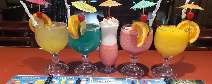Colorful cocktails with umbrellas at a restaurant table