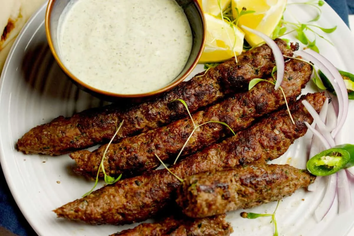 Grilled seekh kebabs served with mint yogurt sauce