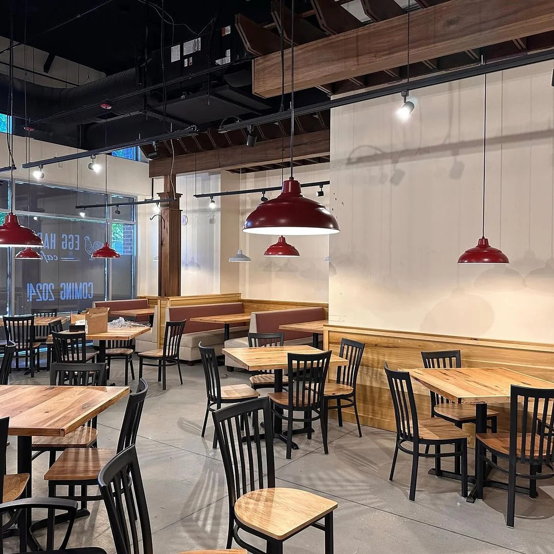 Cozy restaurant interior with wooden tables and red pendant lights