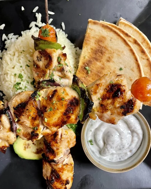 Grilled chicken kebab platter with rice and yogurt sauce