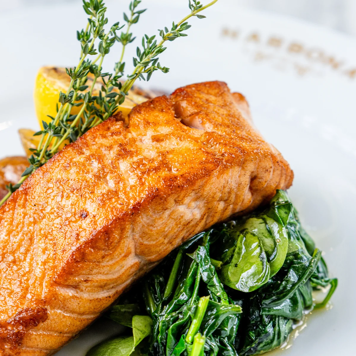 Grilled salmon fillet with sautéed spinach