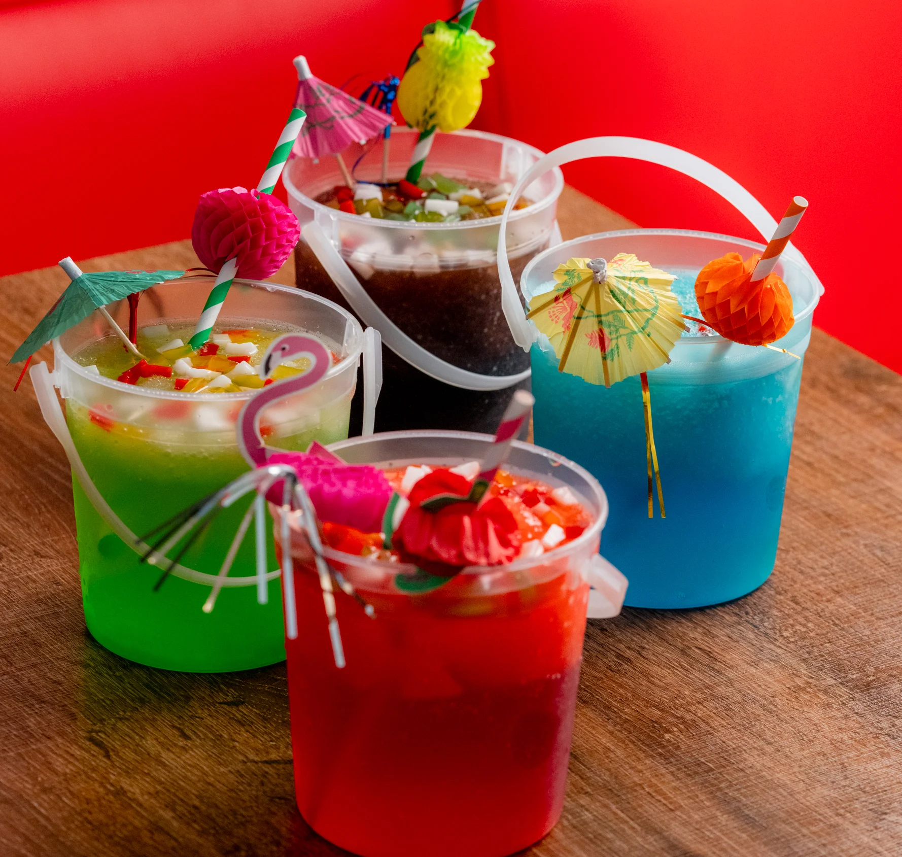 Vibrant purple cocktail garnished with lime and herbs