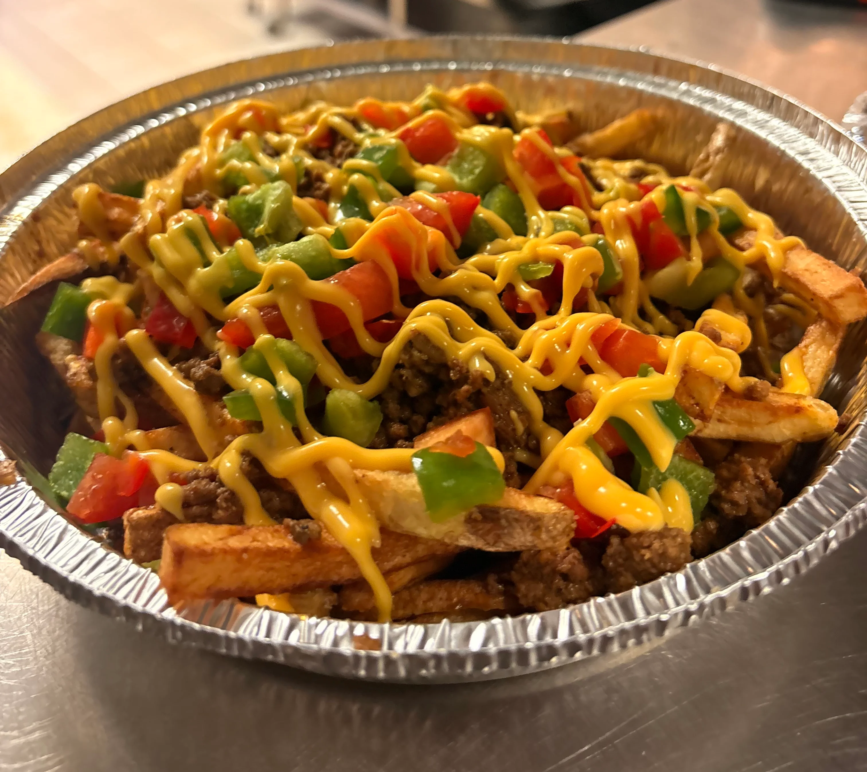 Loaded nachos topped with cheese and fresh vegetables