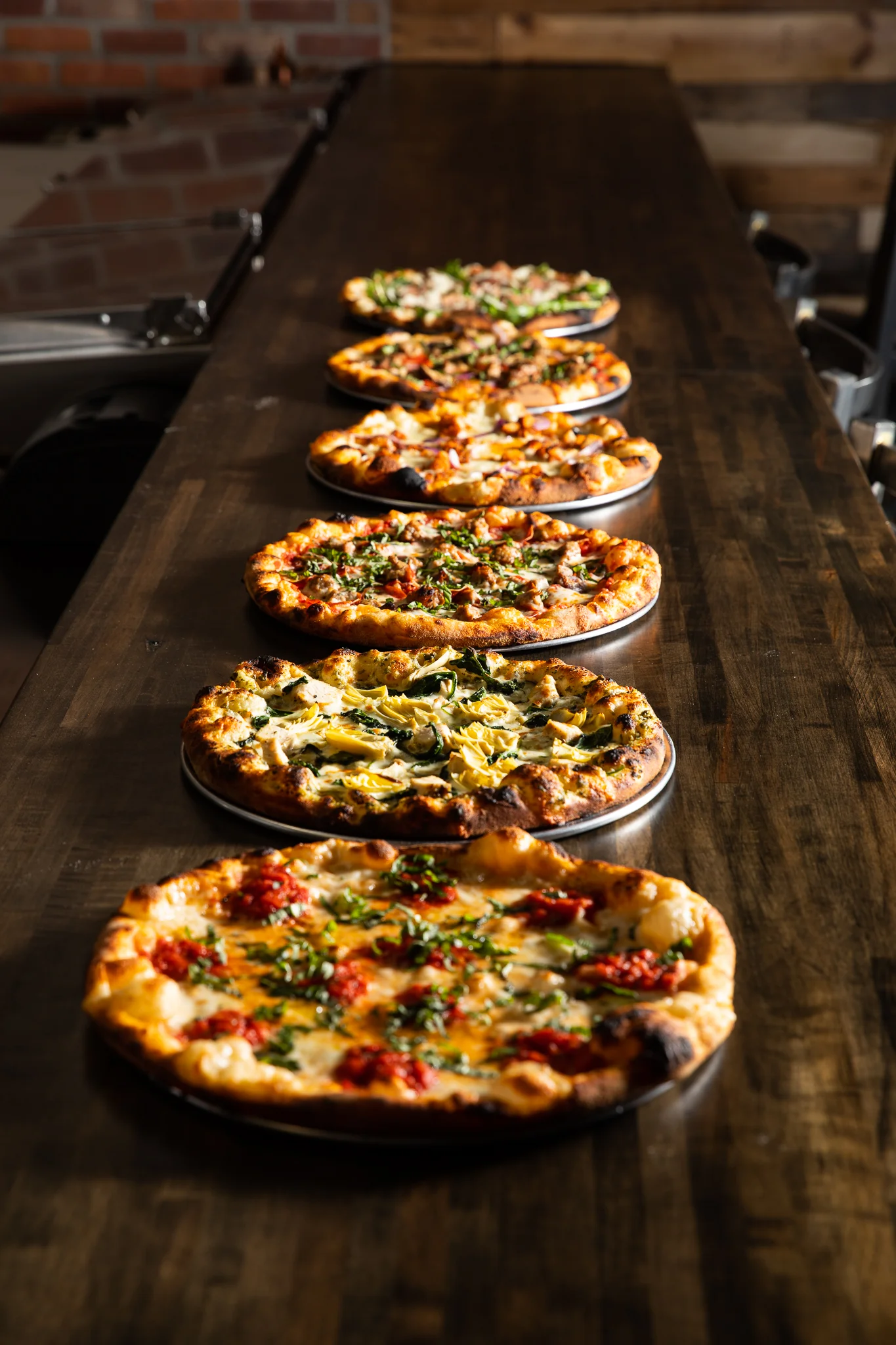 A line up of hot and ready pizzas