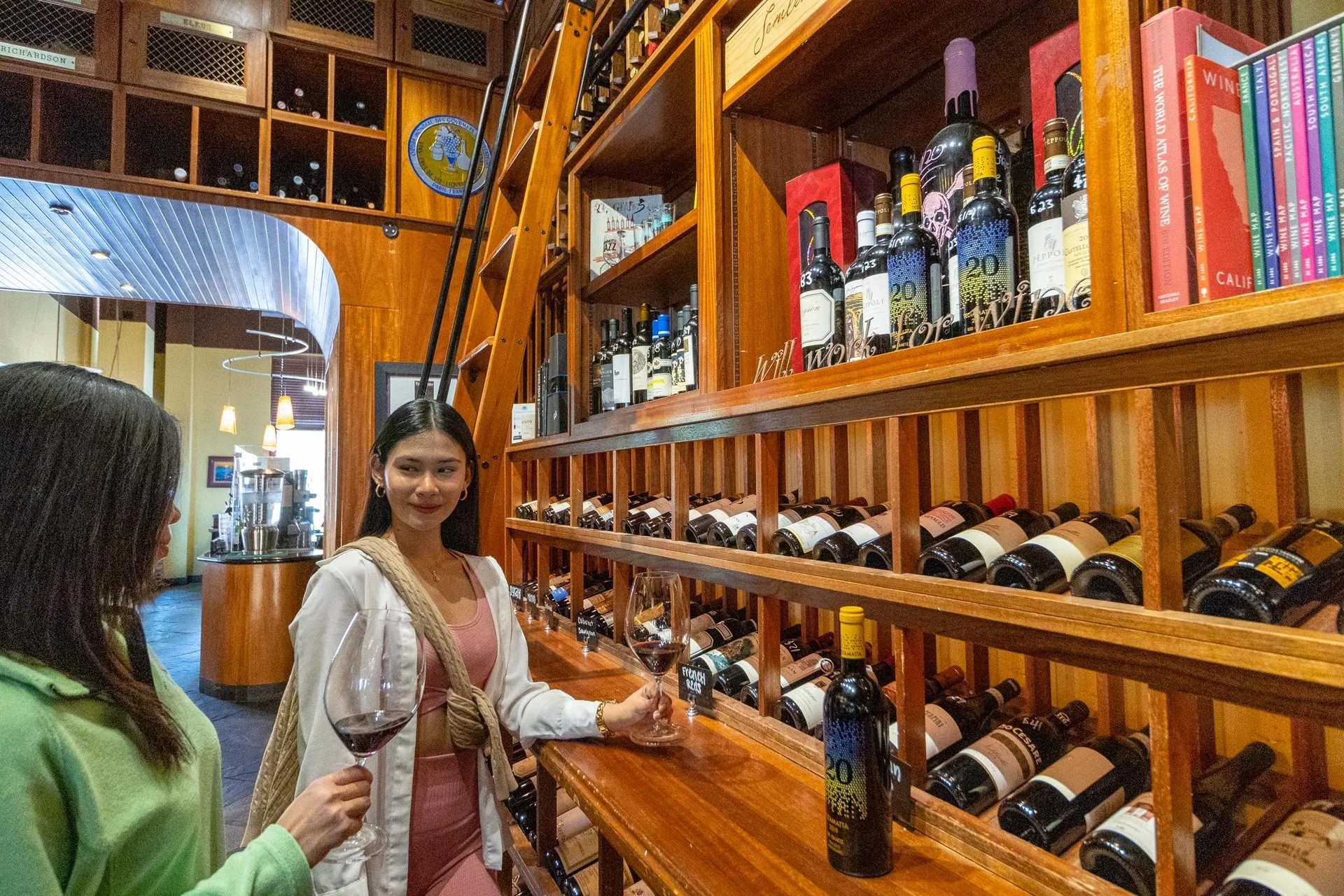 Friends enjoying wine together at Side Door Wine Bar & Café, showcasing the cozy space available for private events and celebrations.