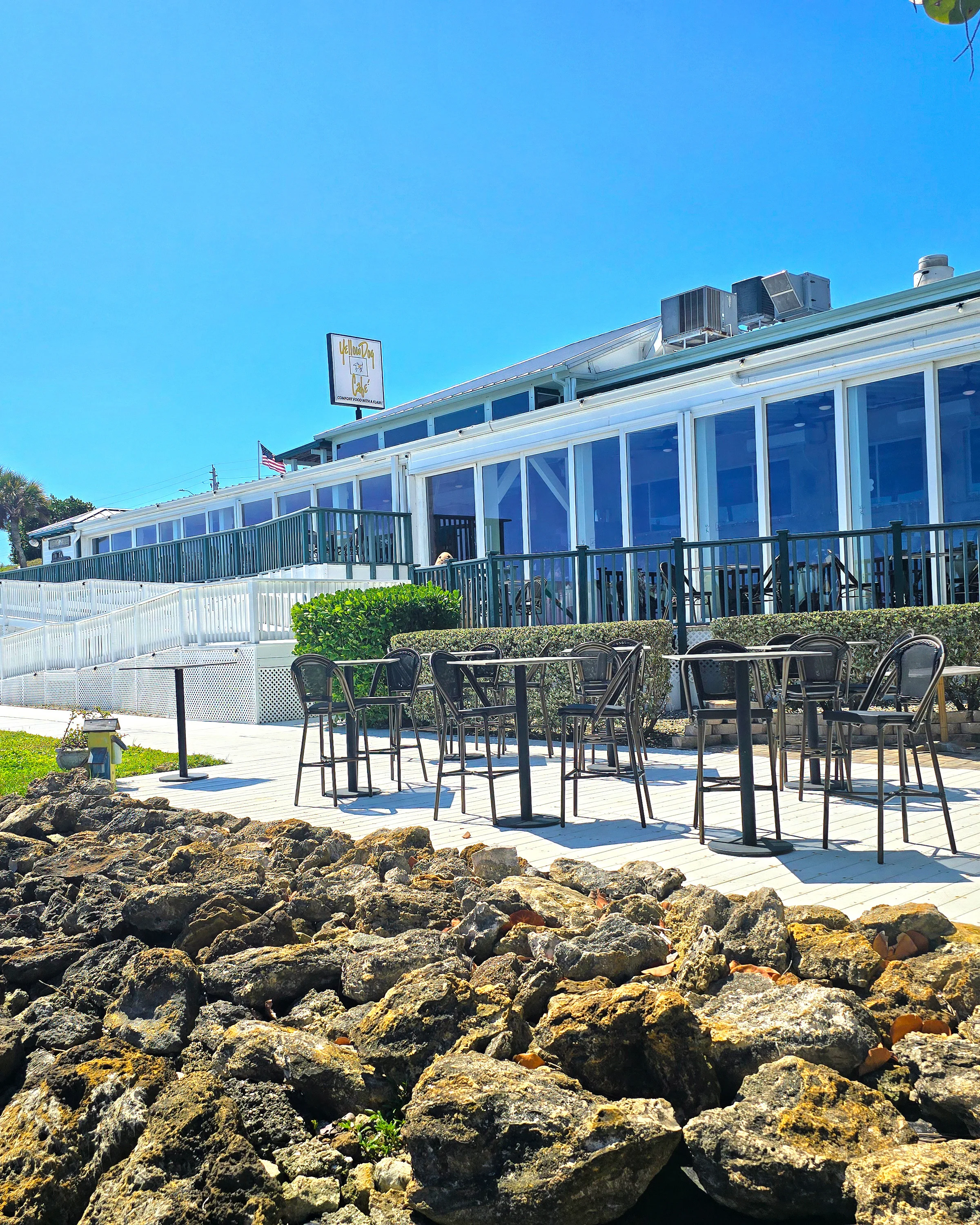 Outdoor dining area of a coastal restaurant with a view