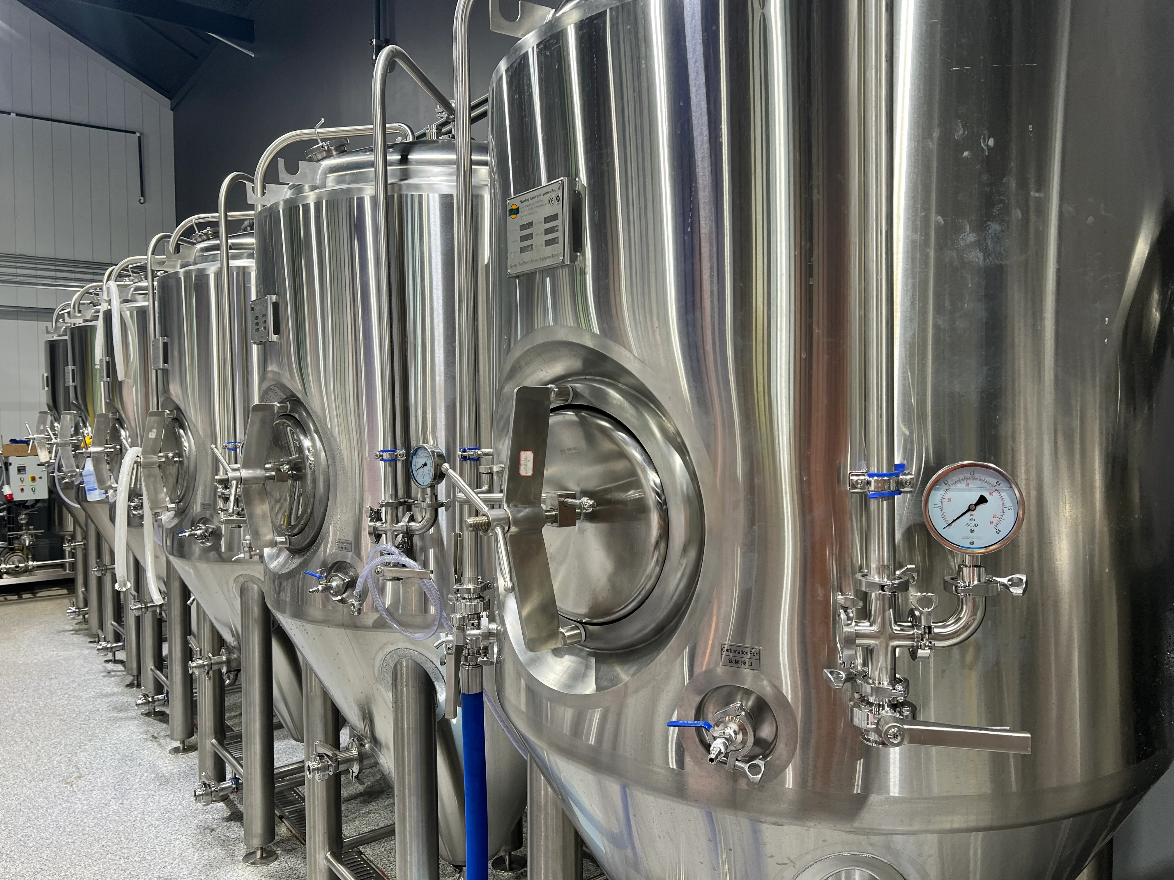 Modern brewery with stainless steel fermentation tanks