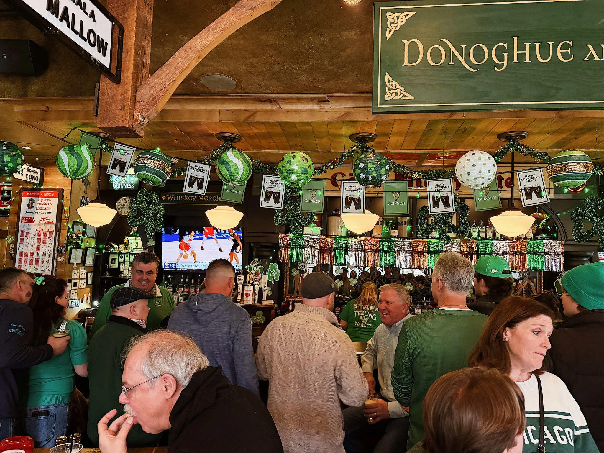 Guests gathered around the bar for a celebration at Mystic Rogue