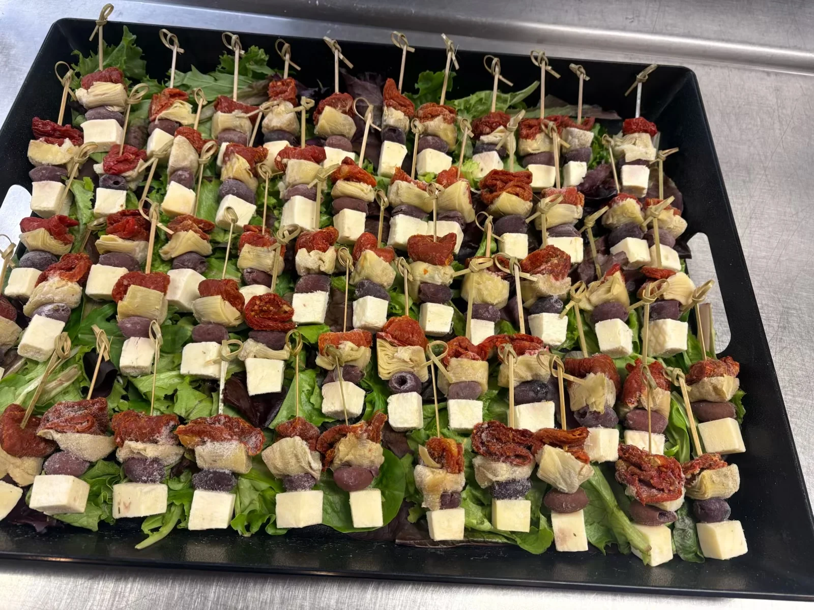 Mediterranean antipasto skewers on a bed of greens