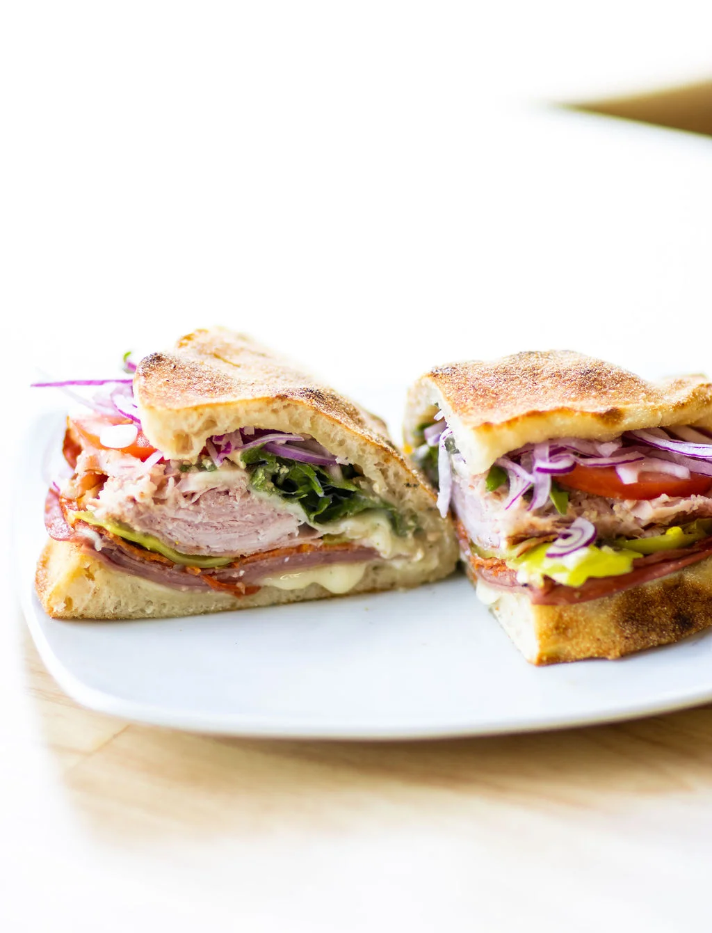 Italian sub sandwich with layers of meats and fresh vegetables