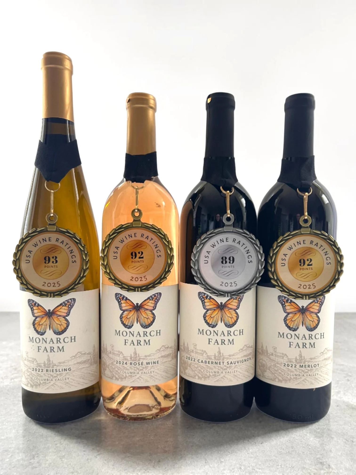 Four Monarch Farm wine bottles with USA Wine Ratings medal seals scoring 93, 92, 89 and 92 points