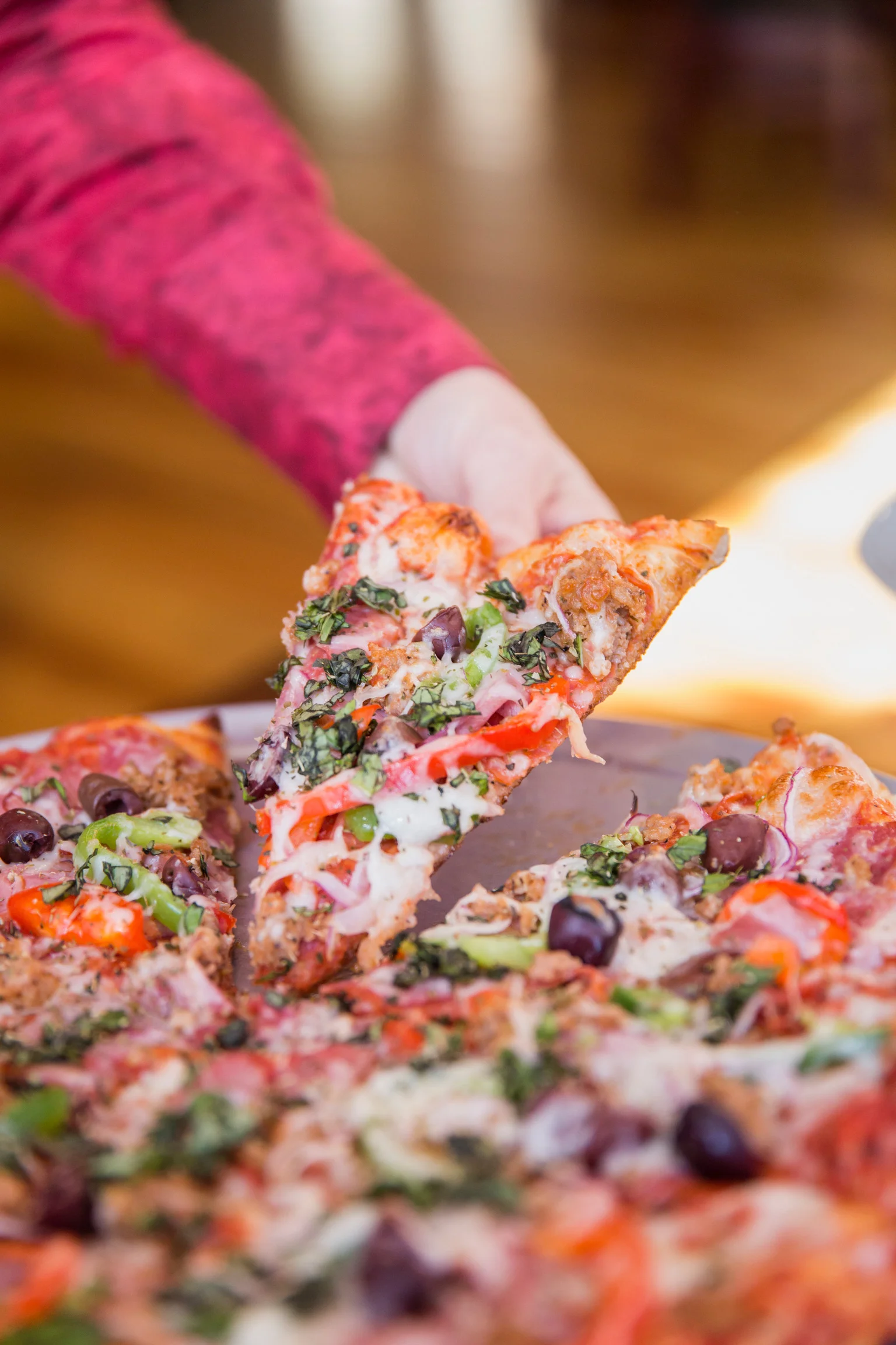 Delicious slice of Mediterranean pizza topped with fresh vegetables