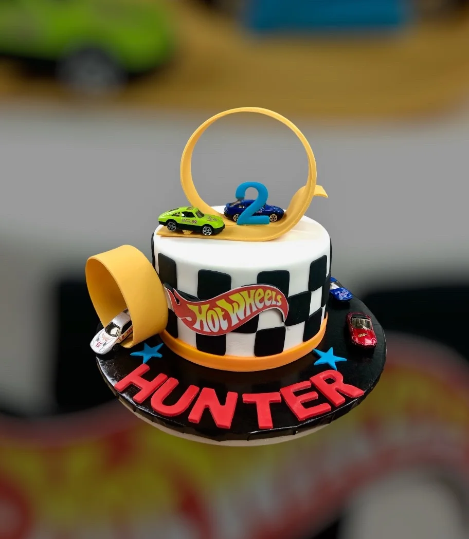 Colorful Hot Wheels birthday cake with racing theme