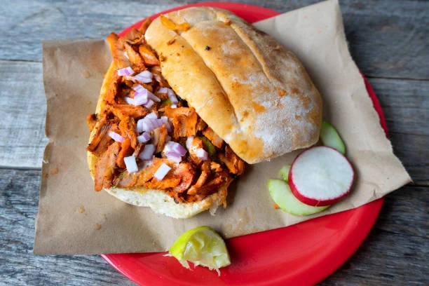 Mexican torta with marinated meat and onions
