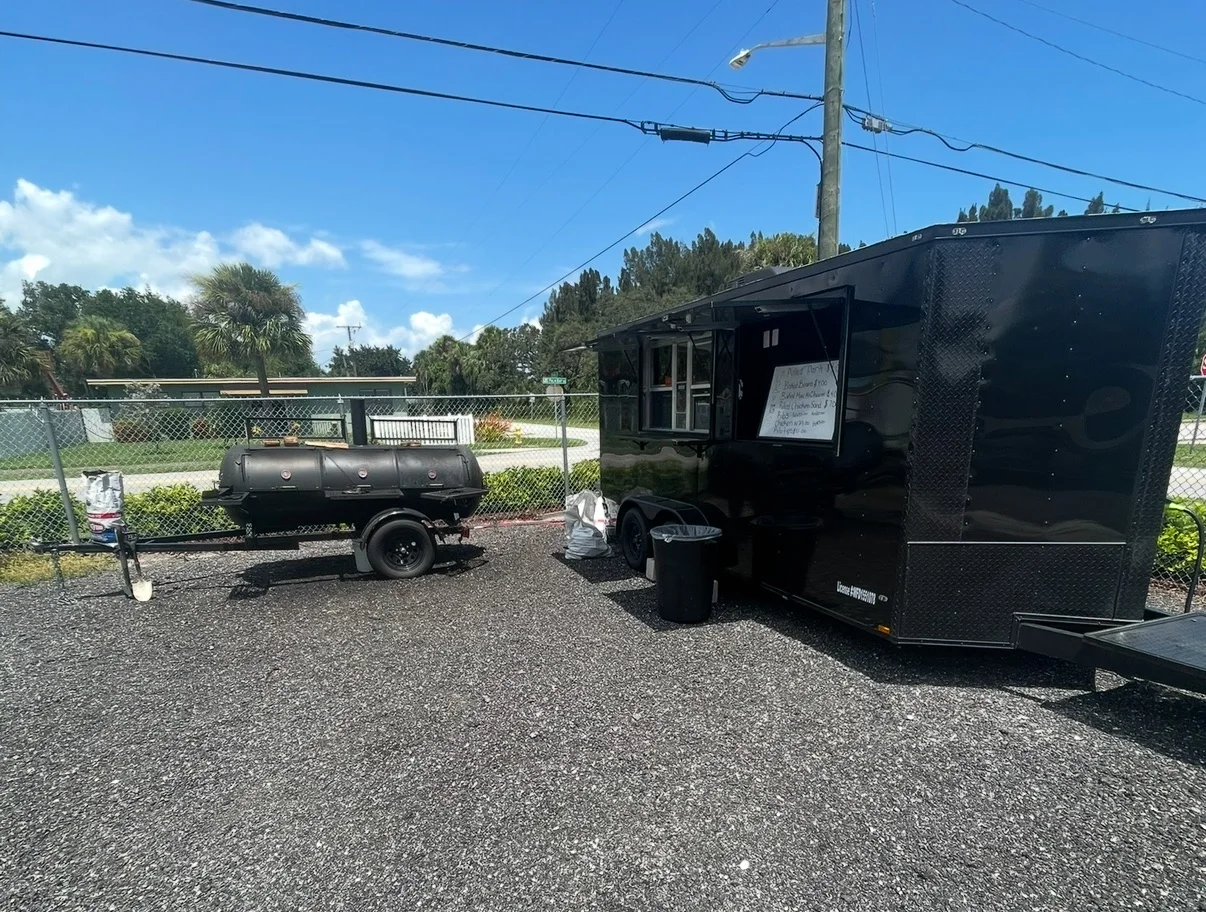 Food truck with a smoker in a sunny outdoor setting