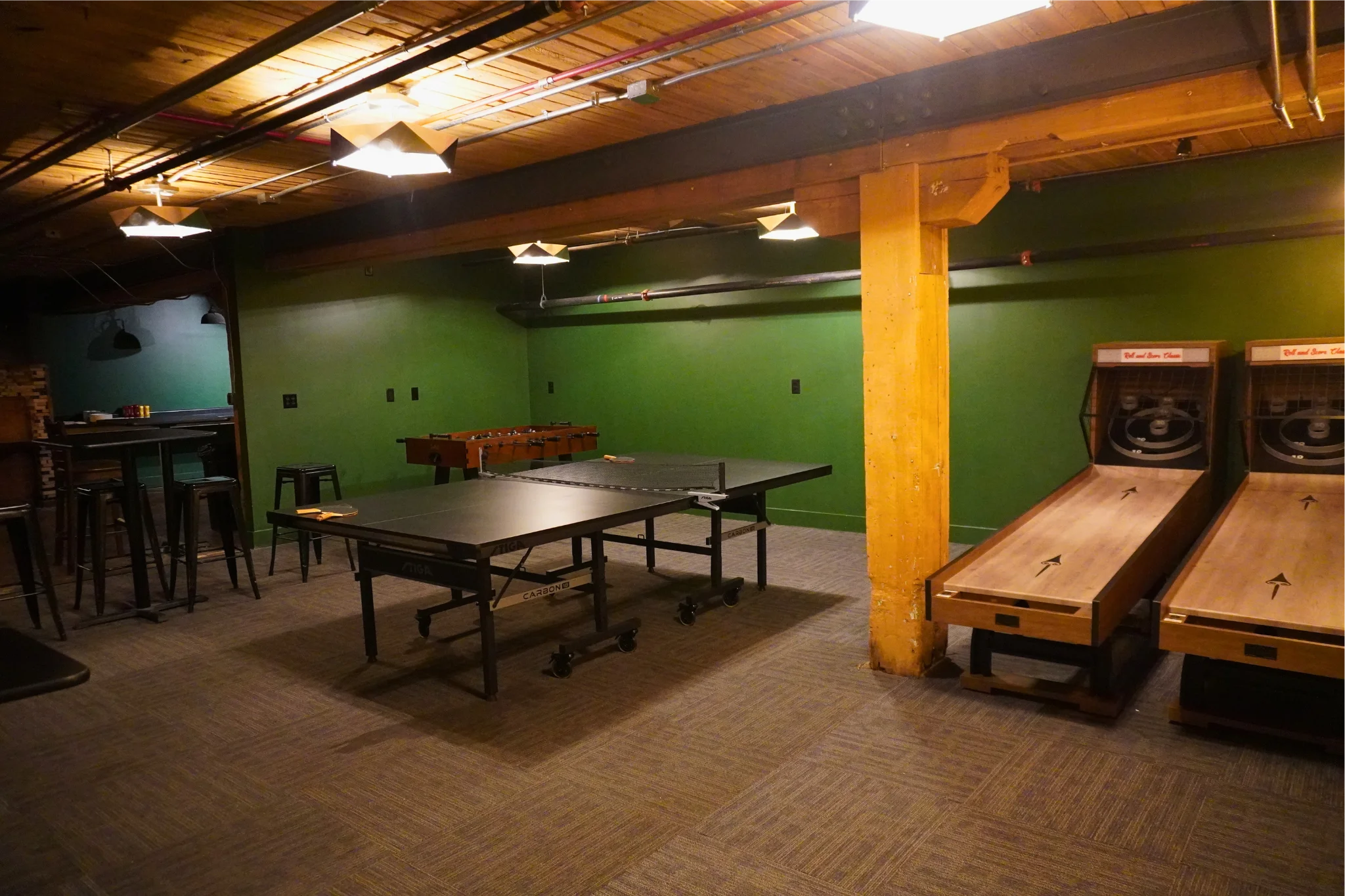 Game room with foosball and shuffleboard tables