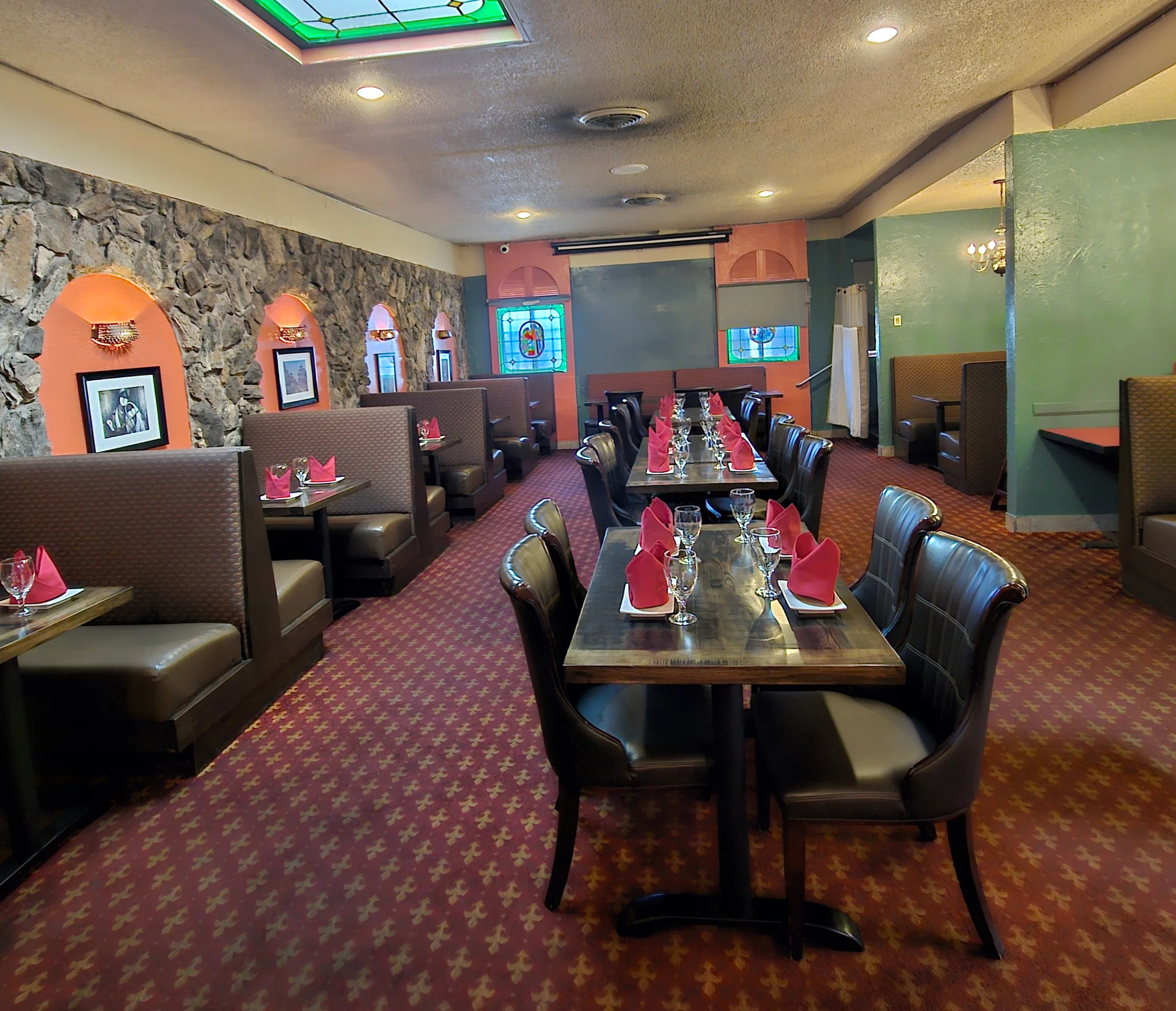 Sugandh private dining room set with tables, glassware, and red napkins