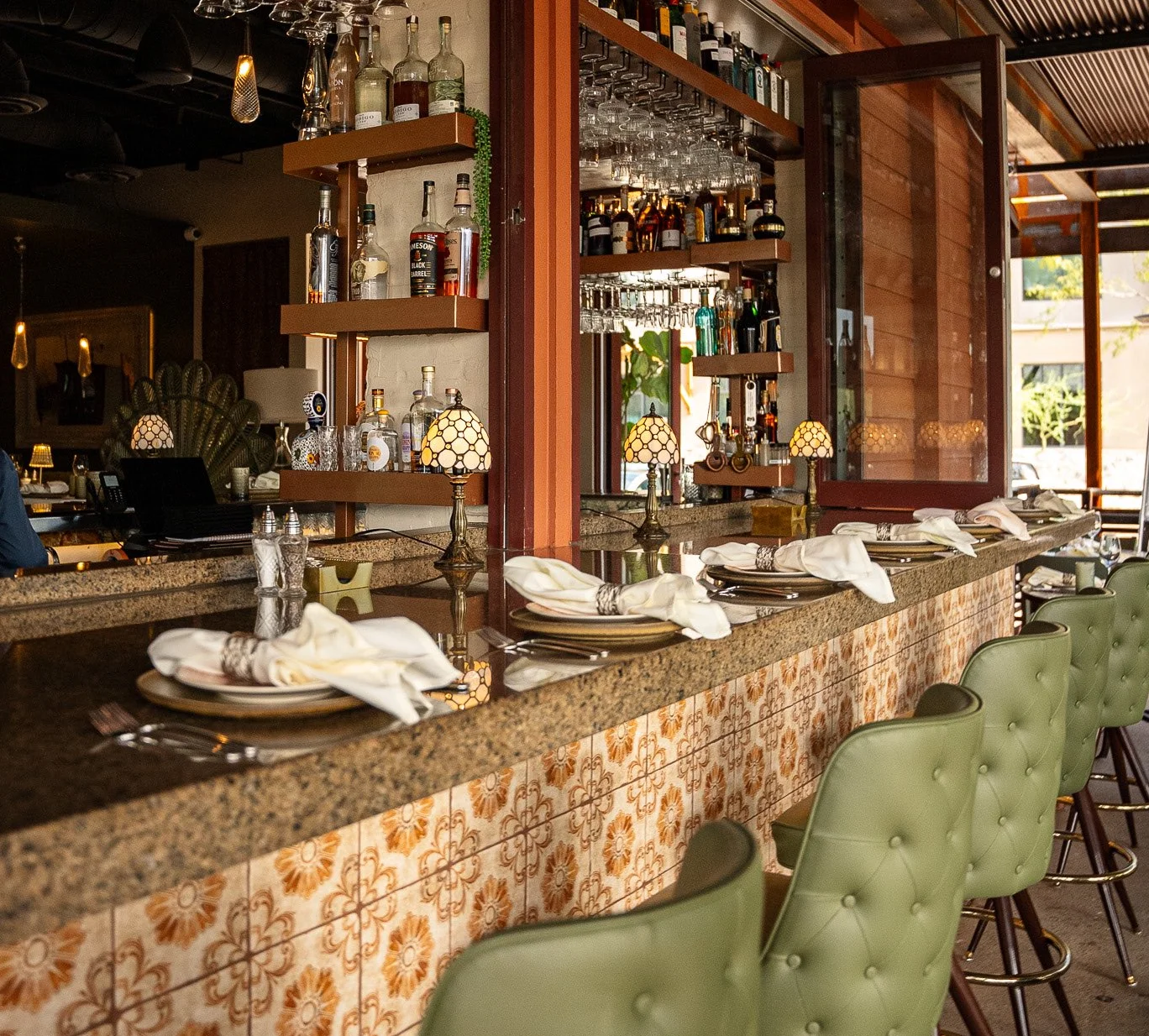 Stylish bar counter with drinks and elegant seating