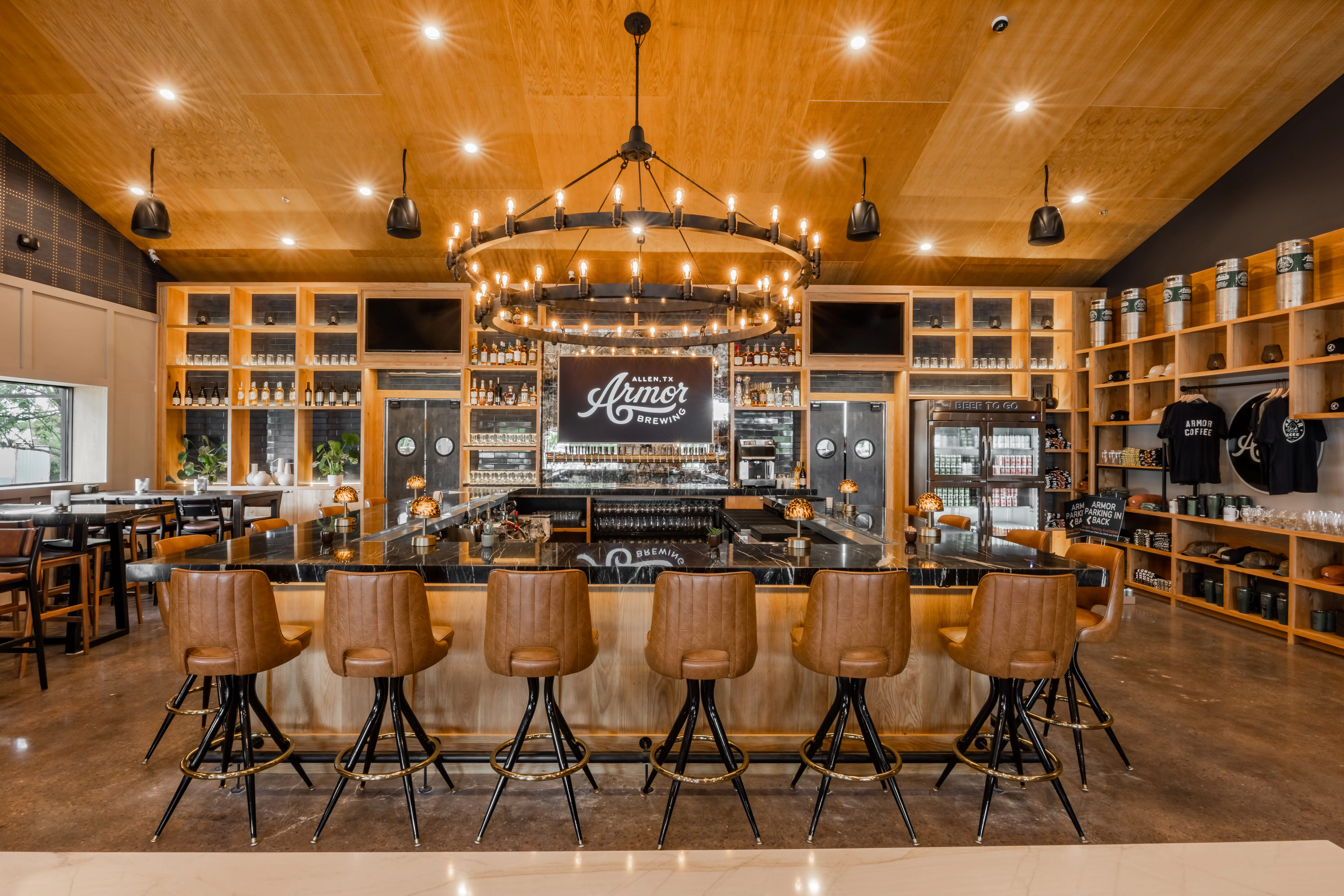 A vibrant brewery interior with wooden decor and patrons enjoying drinks.