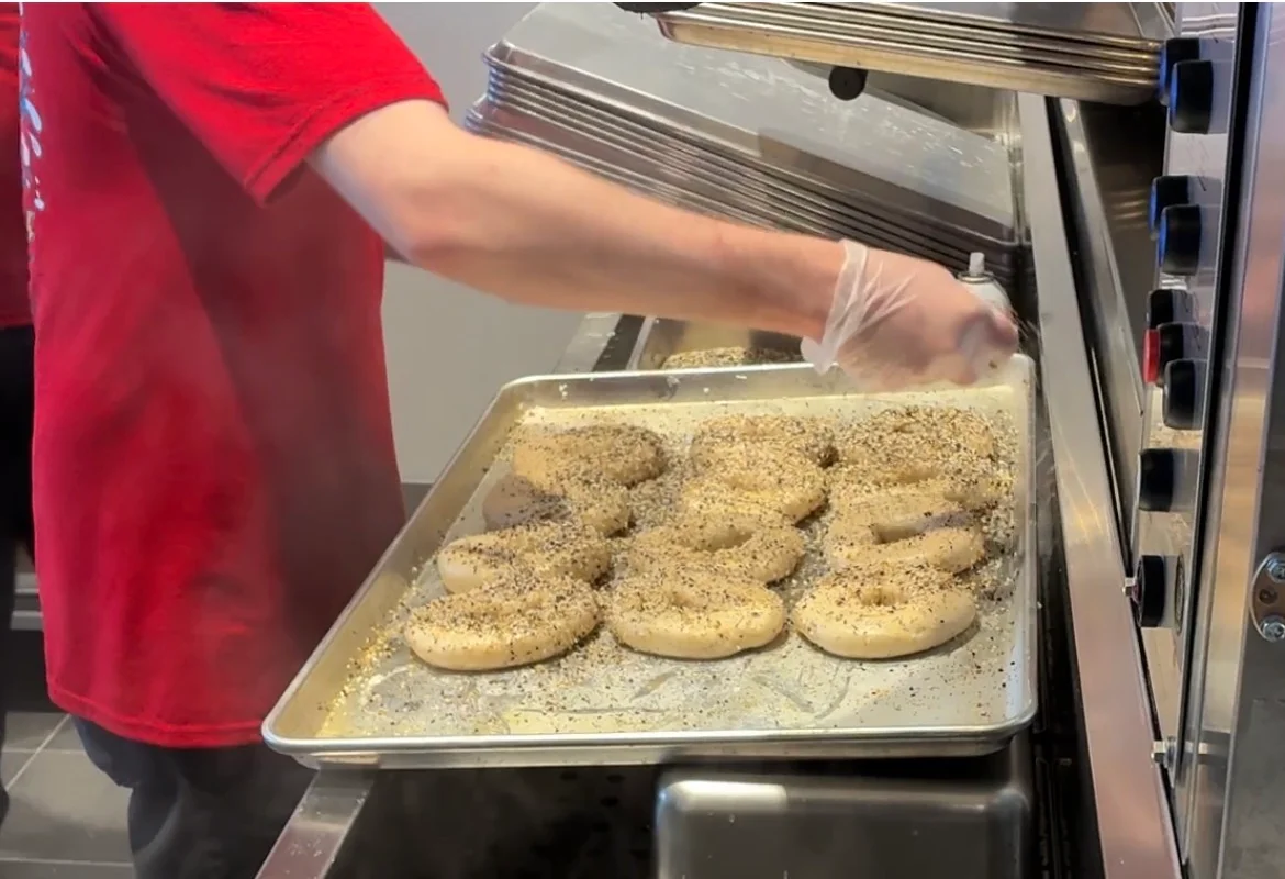 Freshly seasoned bagels ready for baking
