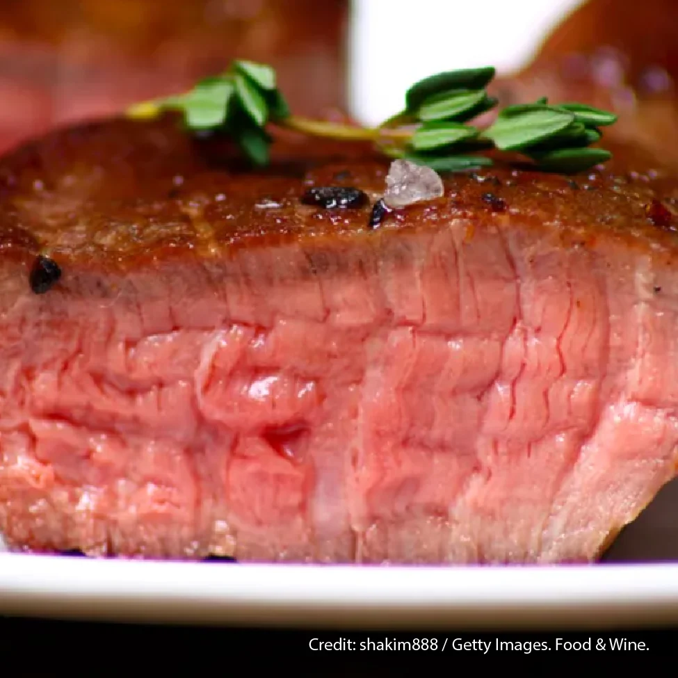 Perfectly cooked medium-rare steak with herbs