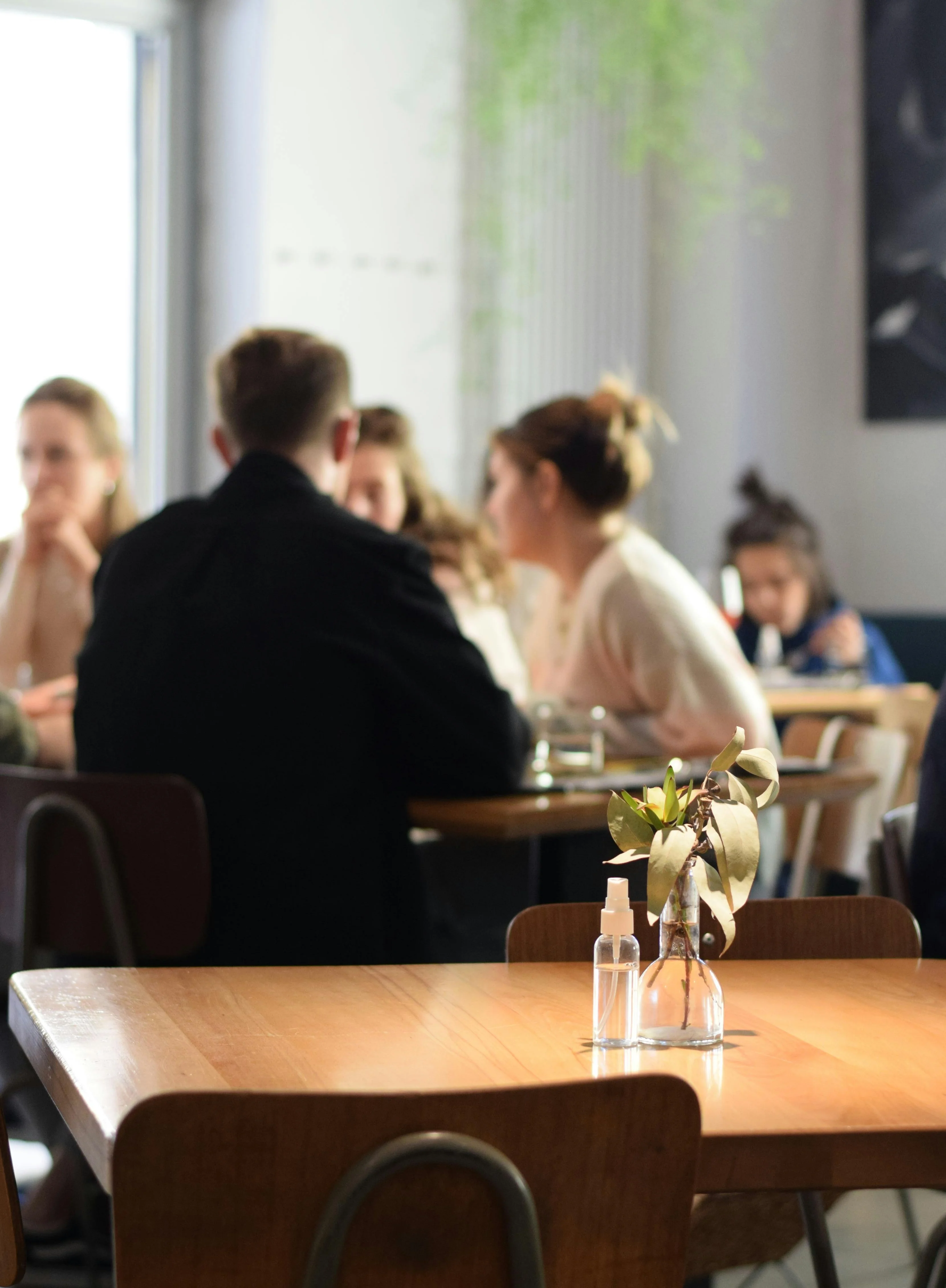 Cozy restaurant interior with wooden tables and plants