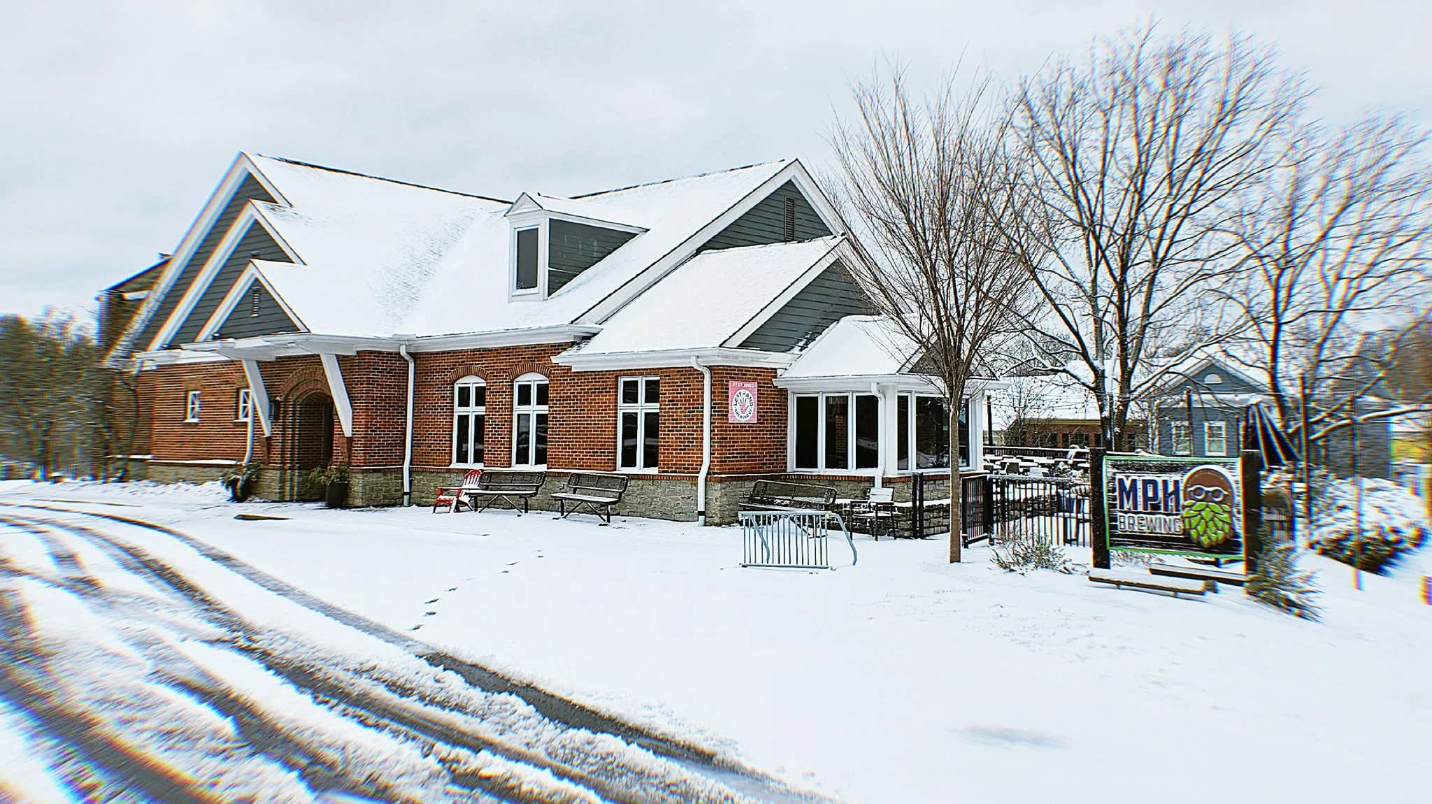 Charming brewery exterior in winter with snow-covered landscape