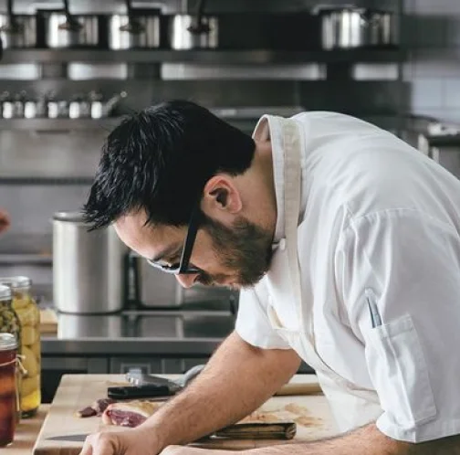 A restaurant chef preparing a dish
