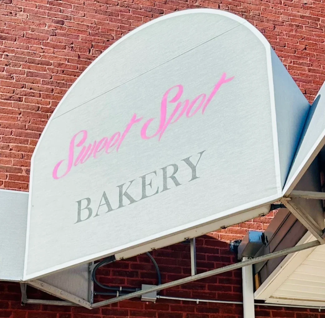 Signage for Sweet Spot Bakery on a brick wall