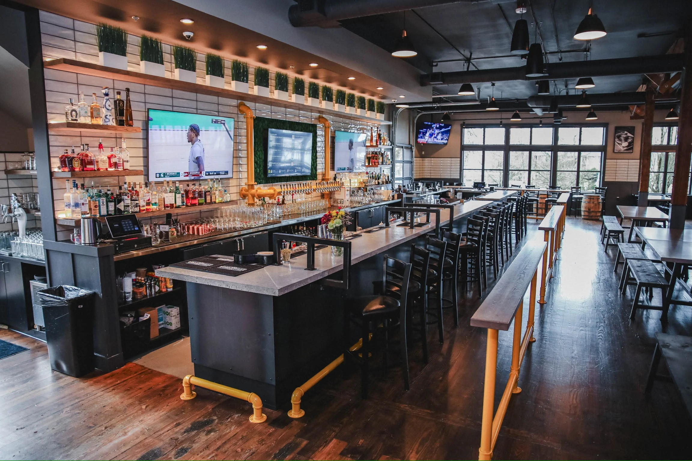 Modern bar interior with sleek design and multiple screens