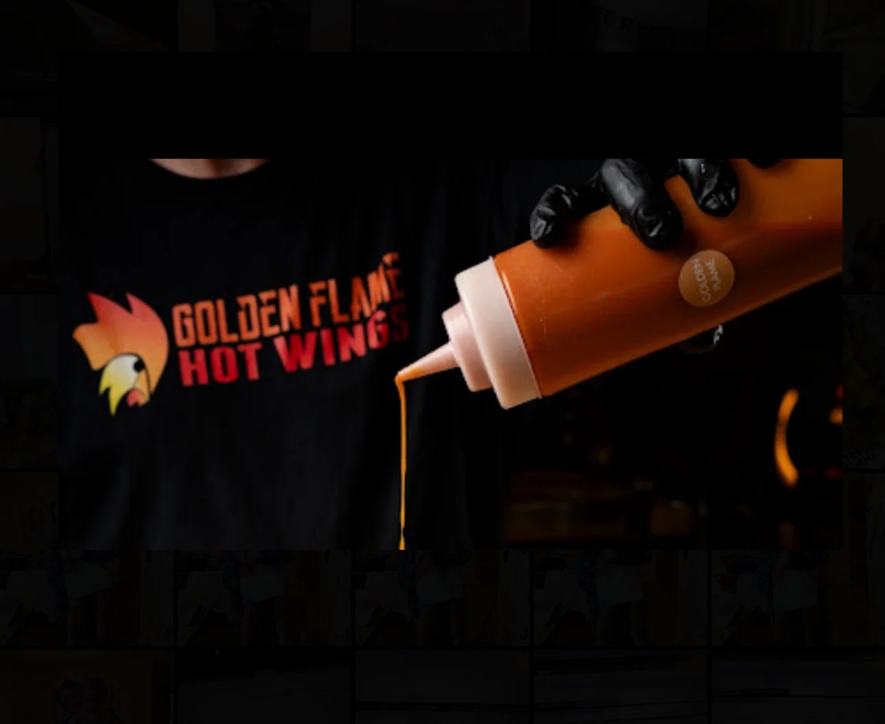 Golden Flame Hot Wings sauce being poured from a bottle