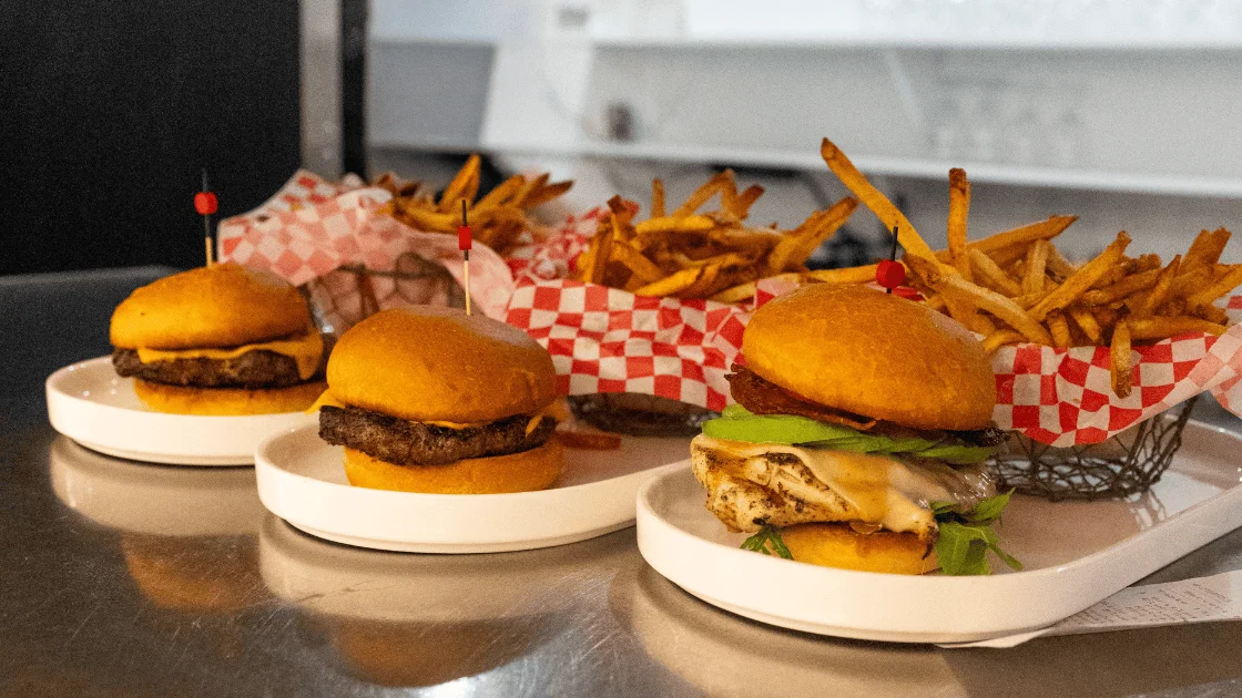 Gourmet burgers with fries served in a modern restaurant