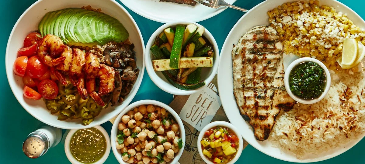 Colorful Latin American feast featuring grilled meats and fresh vegetables