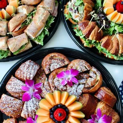 Assorted pastry platter with croissants and fruit garnishes