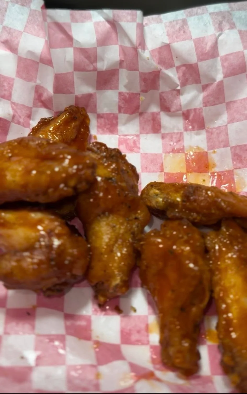 Delicious chicken wings served with dipping sauce on a plate.