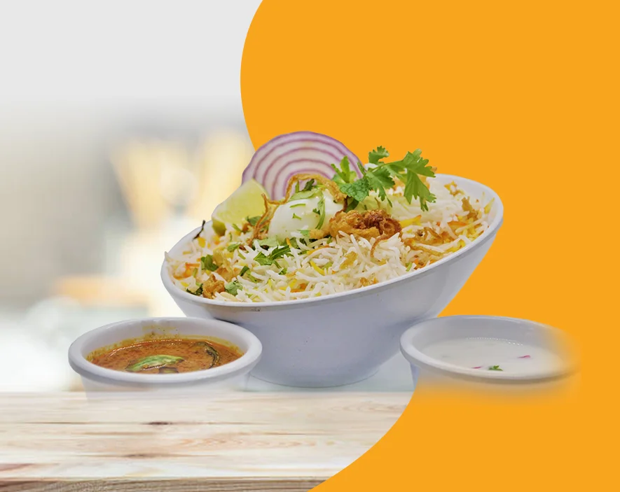 Delicious biryani served with raita and curry