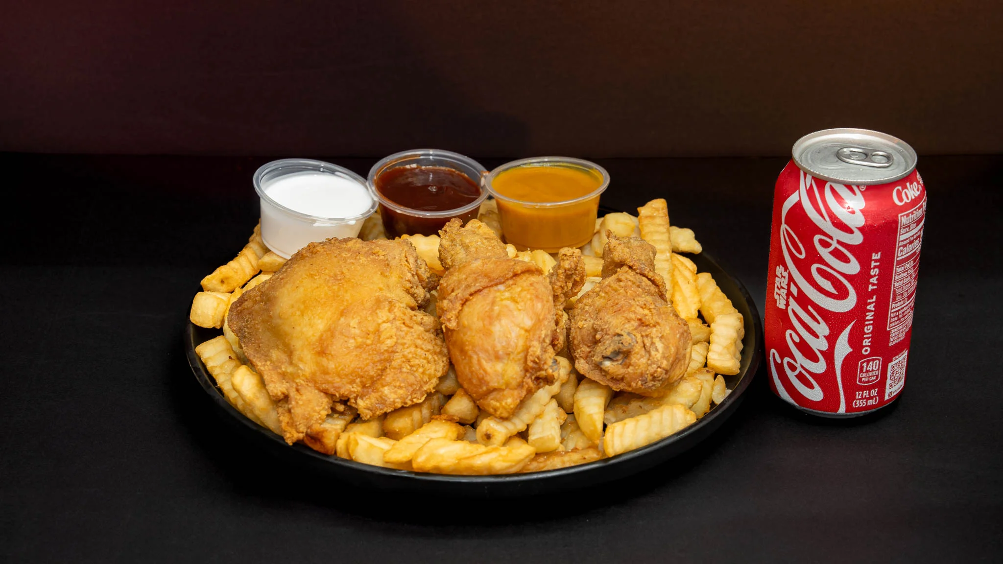 Crispy fried chicken with fries and dipping sauces