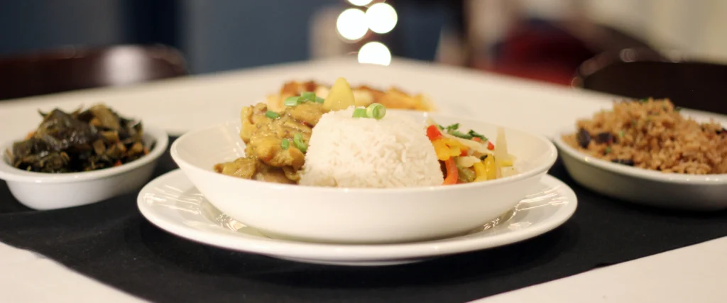 Jamaican curry chicken with rice and sides