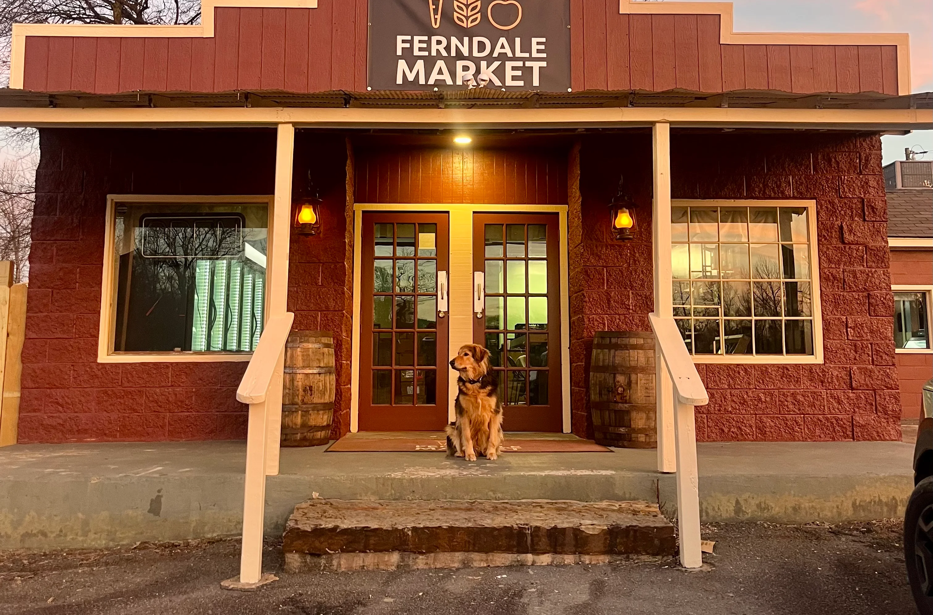 Charming market exterior with a welcoming entrance and a dog