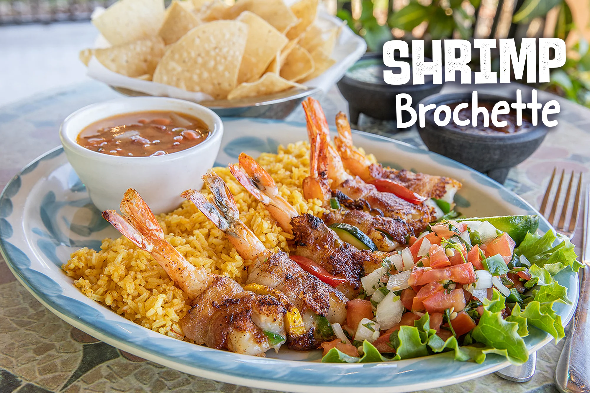 Delicious shrimp brochette served with rice and salsa