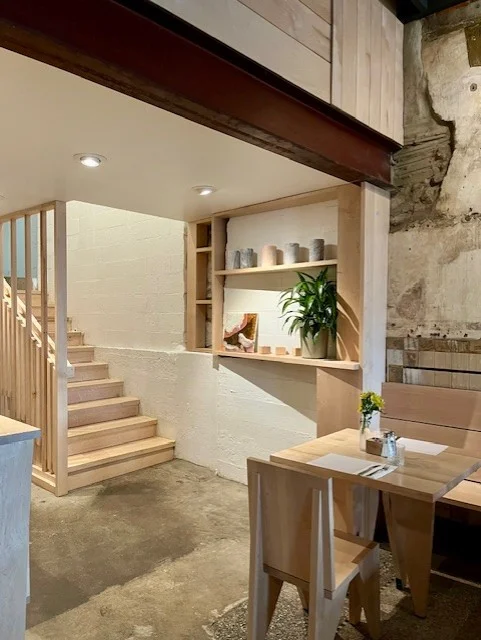 Cozy restaurant interior with wooden decor and staircase