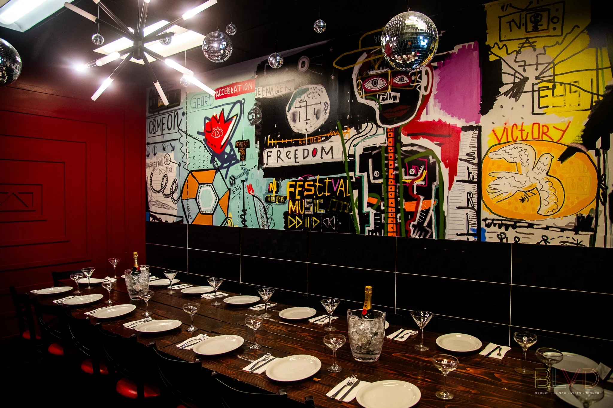 Vibrant restaurant interior with artistic mural and elegant dining setup